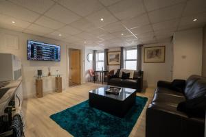 a living room with a couch and a coffee table at Luxury 1bed - Contractors Welcome - Fast WiFi in Cleethorpes
