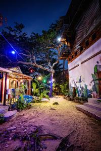 a street at night with lights on a building at Easy Tiger - M'Pai Bay Beach, Koh Rong Sanloem in Koh Rong Sanloem