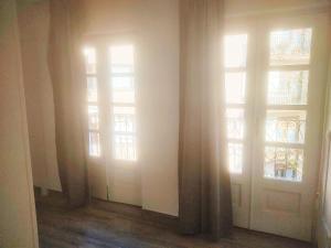 a room with two doors and two windows at Apartamento HOTEL LAUAXETA in Mungia