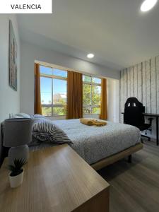a bedroom with a bed and a large window at CoLiving El Juanito in Las Palmas de Gran Canaria