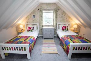 a attic bedroom with two beds and a window at Stunning Property On The North York Moors in Stokesley