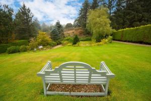 a white bench sitting in the middle of a lawn at Stunning Property On The North York Moors in Stokesley