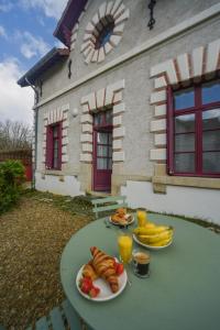 two plates of food on a table in front of a house at Les Carnaux- Parking - Terrasse in Ballan-Miré