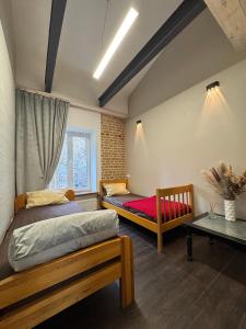 Кровать или кровати в номере Apart-Hotel IGORIVSKA +55 фотографий