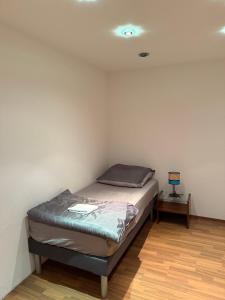 a small bedroom with a bed and a night stand at Stilvolles Apartment mit Dachterrasse in Garbsen