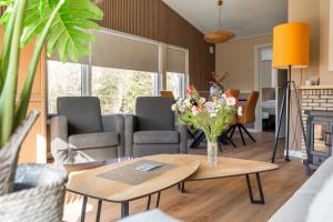 a living room with a vase of flowers on a table at Joossesweg 94 in Westkapelle