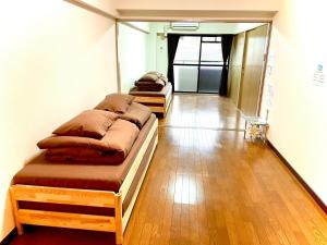 OrioゲストハウスＥn プレザント203的客房内的两张床拼在一起。