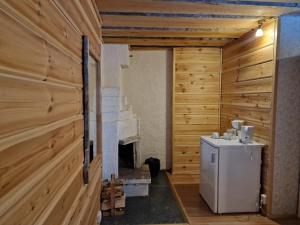 a room with a fireplace and a refrigerator in it at Tankavaara Gold Village in Tankavaara +113 photos