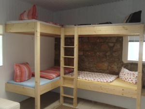 a bunk bed with two bunk beds in a room at Hostel Vorharz Quedlinburg in Quedlinburg