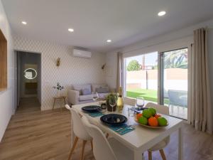 a kitchen and living room with a table and chairs at Refurbished 2 bedrooms house private pool in San Bartolomé de Tirajana