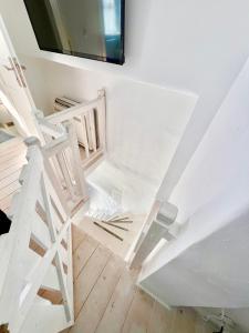 a room with white stairs and a mirror at Kyma Apartments-Little Venice,Mykonos in Mikonos