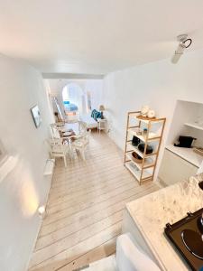 a living room with a table and a dining room at Kyma Apartments-Little Venice,Mykonos in Mikonos
