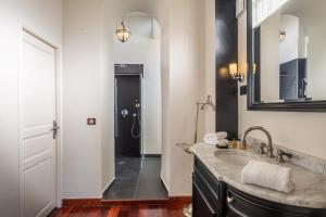 a bathroom with a sink and a shower at La Villa Mauresque in Saint-Raphaël