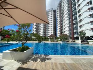 a swimming pool in the middle of some buildings at Jono's Flat Royal Oceancrest in Lapu Lapu City