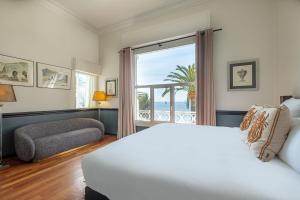 a bedroom with a bed and a large window at La Villa Mauresque in Saint-Raphaël