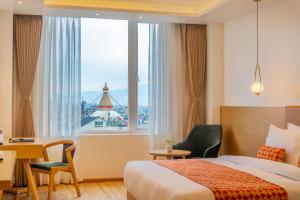 A bed or beds in a room at Hotel Anuttara