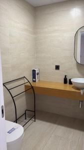 a bathroom with a toilet and a sink at LHOME CÁDIZ in Cádiz