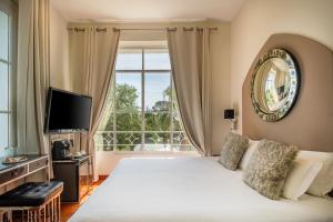 a bedroom with a bed and a large window at La Villa Mauresque in Saint-Raphaël