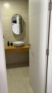 a bathroom with a sink and a mirror at LHOME CÁDIZ in Cádiz