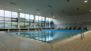 a large swimming pool in a large building at Parkhotel Olsberg in Olsberg