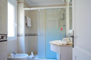 a bathroom with a glass shower and a sink at Balcon de Jandia Studio in Morro del Jable +6 photos