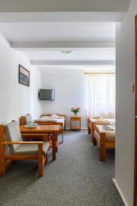 a hotel room with chairs and a table and beds at Kosewo 78 Family Hotel & Spa in Kosewo