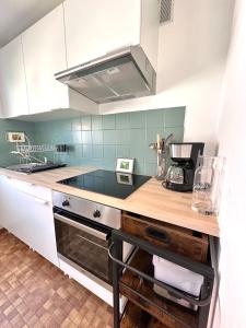 a kitchen with a sink and a counter top at ANNE - Maisonnette confortable avec Cour privée à Berck-Plage in Berck-sur-Mer
