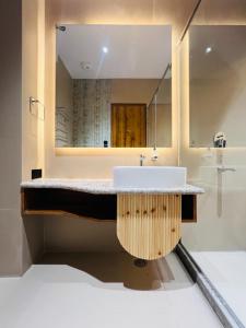 a bathroom with a sink and a mirror at Hotel Virasat-E-Bushahr in Rāmpur