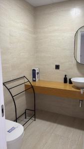 a bathroom with a toilet and a sink at LHOME CÁDIZ in Cádiz