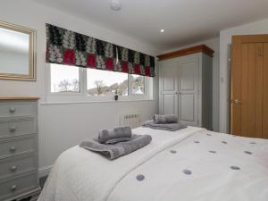 a bedroom with a large bed with two pillows on it at Yewdale View Apartment in Coniston