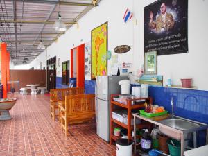 a kitchen with a refrigerator and a sink in a room at Runa Runa The Best Samed Island in Ko Samed