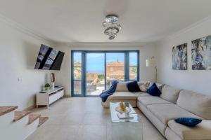 a living room with a couch and a table at Charming semi- detached villa in Mirador del Duque in Adeje