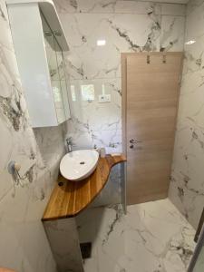 a white bathroom with a sink and a shower at Pag Apartment in Pag +42 photos