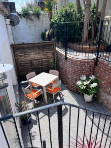 a patio with a table and chairs on a balcony at Central Falmouth with parking & courtyard in Falmouth