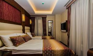 a hotel room with a bed and a television at Vertu istanbul in Istanbul