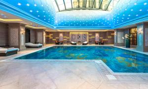 a large pool in a hotel with a ceiling at Narcissus Riyadh Hotel & Spa in Riyadh