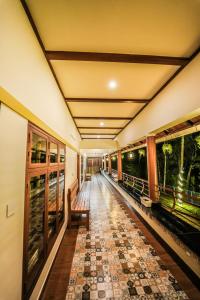 an empty corridor of a building with a floor of tiles at Swasta Royal Villas Wayanad in Kaniyāmbetta