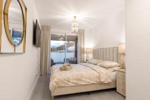 sypialnia z dużym łóżkiem i lustrem w obiekcie Cala Serena - Beautiful 2-bedroom apartment 850 meters from the beach w mieście La Cala de Mijas