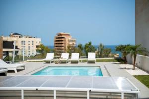 a swimming pool on the roof of a building at Villa Palm Beach - Incredible villa with 5 rooms, amazing sea view and private pool in Fuengirola