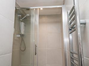 a shower with a glass door in a bathroom at Flat 1 in Penzance +8 photos