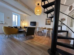 a living room with a couch and a dining room at Maison 4 pièces 6 couchages Saint Denis d'Oléron SDO000-382 in Saint-Denis-dʼOléron