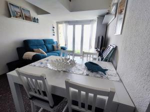 a dining table and chairs in a living room at Apartamentos con vistas al mar in Platja  d'Aro