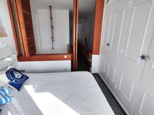 a small room with a bed and a mirror at Apartamentos con vistas al mar in Platja  d'Aro