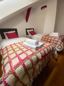 a bedroom with two beds with towels on them at Apartamenty Plac Moniuszki 11 City Center in Kielce +68 photos