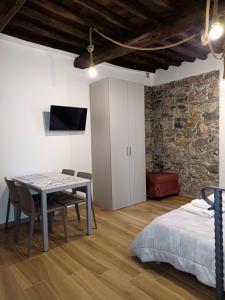 a room with a table and chairs and a bed at Matt house in La Spezia