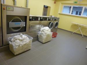 a laundry room with two washers and a dryer at Hotel Emonec in Ljubljana