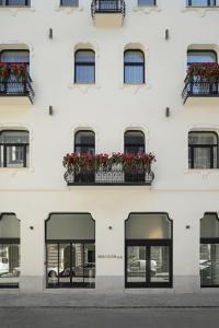 a white building with windows and flower boxes at Maison 45 - Luxury Boutique Hotel in Budapest