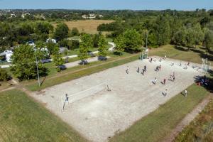 an overhead view of people playing a game in a park at Camping Seasonova Le Plan d'Eau in Saint-Yrieix-sur-Charente +16 photos