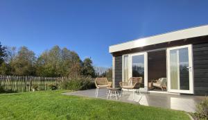 a patio with chairs and a house at B&B Bed in Burgh in Burgh Haamstede