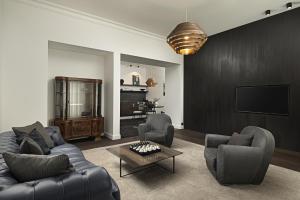 a living room with two couches and a tv at Maison 45 - Luxury Boutique Hotel in Budapest